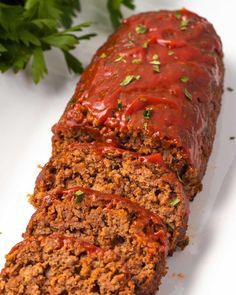 sliced meatloaf with sauce and parsley on top