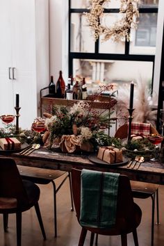 the table is set with christmas decorations and candles