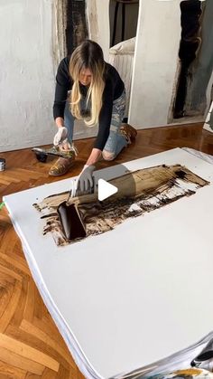 a woman is working on an art project