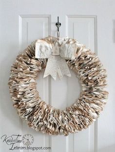 an image of a wreath made out of books on the front door with a bow