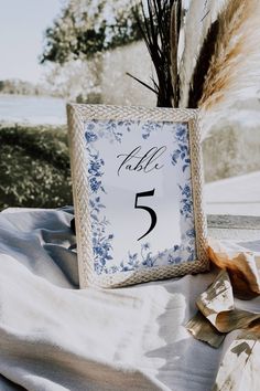 the table numbers are displayed in blue and white floral designs, along with dried pamodia