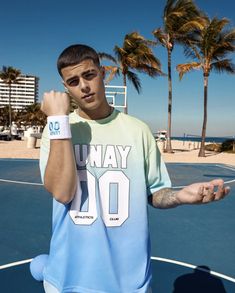 a man standing on top of a basketball court holding his fist up in the air