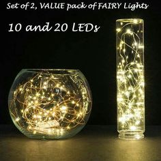 two glass vases with fairy lights in them