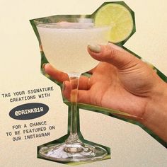 a hand holding a martini glass with a lime on the rim and an ad for gin