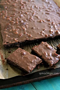 chocolate brownies are cut into squares and placed on a baking sheet, ready to be eaten