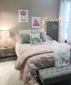 a bedroom decorated in pink and grey with lights