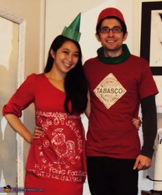 a man and woman dressed up in elf hats standing next to each other with their arms around each other