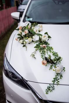 flowers on the hood of a white car