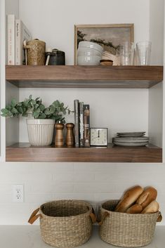 two baskets filled with bread sitting on top of a counter next to books and other items