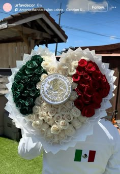 a person wearing a white jacket with red, green and white roses in the center