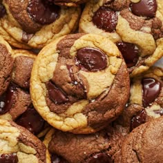 chocolate chip cookies are piled on top of each other with one cookie in the middle