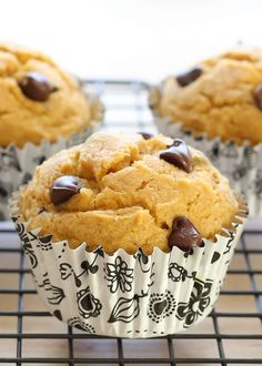 chocolate chip muffins on a cooling rack with another muffin in the background