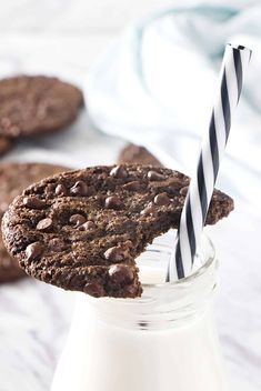 a chocolate cookie in a glass with a striped straw