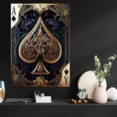 a gold and black ace playing card sitting on top of a table next to some vases