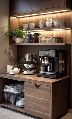 a coffee maker is sitting on top of a wooden cabinet with cups and saucers