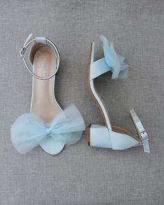 a pair of blue shoes with bows on the toes and heels that have been made to look like they are being worn by someone