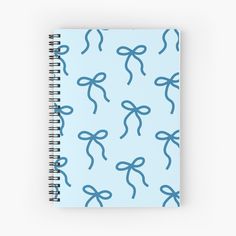 a spiral notebook with blue bows on it