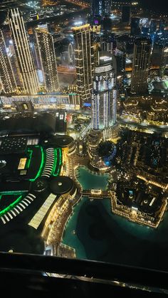 an aerial view of the city lights and buildings at night from high up in the sky