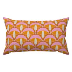 an orange and pink pillow with white designs on it