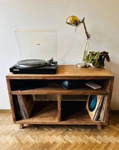 an old record player on top of a wooden shelf