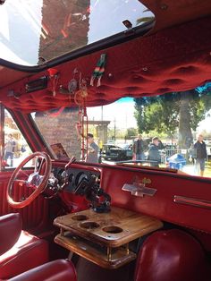 the interior of an old car with red leather seats