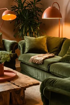 a living room filled with green couches and lamps