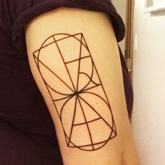 a person with a tattoo on their arm that has an image of a geometric object