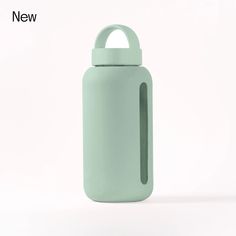 a light green water bottle sitting on top of a white table