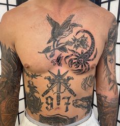 a man with many tattoos on his chest