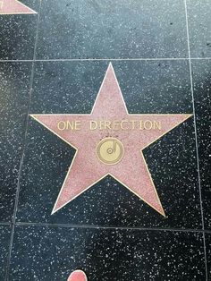 one direction star on the hollywood walk of fame with someone's foot in it