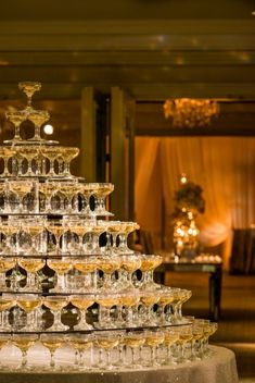 a large stack of glasses sitting on top of a table