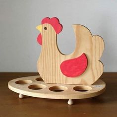 a wooden toy with a chicken on it