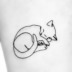 a black and white drawing of a cat sleeping on top of a person's leg