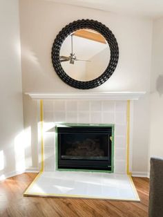 a living room with a fire place and a mirror on the wall over the fireplace