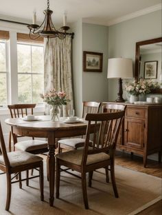 a dining room table with chairs and a chandelier