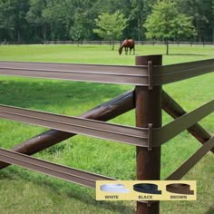 a horse grazing in a field behind a fence with the words black brown on it