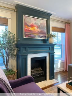 a living room filled with furniture and a painting on the wall above a fire place