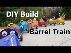 children riding on colorful toy cars with the words diy build barrel train in front of them