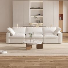 a modern living room with white furniture and wood flooring