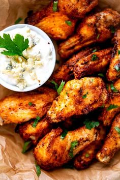 chicken wings with ranch dip and parsley on the side, ready to be eaten