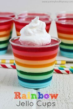 rainbow jello cups with whipped cream in them