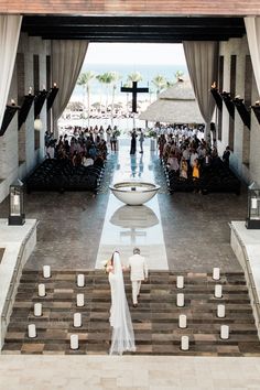 the bride and groom are walking down the aisle