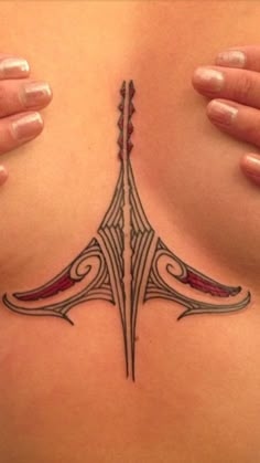 a woman's chest with a tattoo design on the top part of her stomach