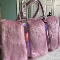 three pink furry handbags sitting on top of a white carpeted floor next to a door