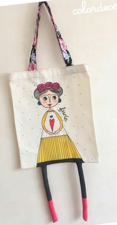 a handbag hanging on the wall with a woman's face painted on it