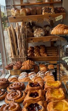 many different types of pastries on display in a bakery