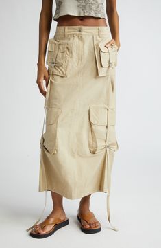 Utility-inspired impact defines this cotton-blend cargo skirt that's packed with pockets and cinched with buckled straps. 32 1/2" length (size 34EU) Zip fly with snap closure Front slant pockets; cargo flap-patch pockets; back zip pocket Adjustable buckle side tabs Back vent Unlined 85% cotton, 15% nylon Dry clean or hand wash, dry flat Made in Portugal Designer Clothing Kharki Cargo Skirt, Utility Beige Cargo Skirt With Side Pockets, Beige Utility Cargo Skirt, Beige Utility Cargo Skirt With Side Pockets, Beige Cargo Skirt With Utility Style, Utility Cotton Cargo Skirt With Belt Loops, Utility Cargo Skirt In Cotton With Belt Loops, Utility Cargo Skirt With Belt Loops In Cotton, Beige Cotton Cargo Skirt With Pockets