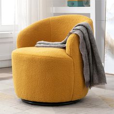 a yellow chair with a blanket on it