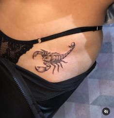 a woman with a scorpion tattoo on her stomach