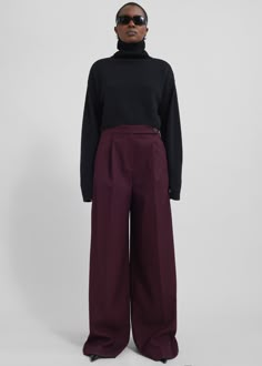 Color: Burgundy Midweight woven fabric Regular fit Wide leg Mid-rise Belt loops Side seam pockets Back illusion welt pockets Zip fly Asymmetric front button closure Unlined 77% Polyester 21% Rayon 2% Elastane Dry Clean By The Frankie Shop. Imported Burgundy Trousers Outfit, Burgundy Pants Outfit, Maroon Pants Outfit, Burgundy Trousers, Cropped Turtleneck Sweater, Maroon Pants, Cropped Turtleneck, Burgundy Pants, Trouser Outfit